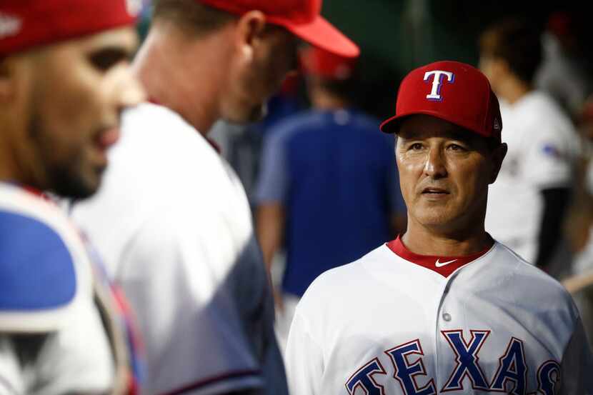 Texas Ranger interim manager Don Wakamatsu greets starting pitcher Connor Sadzeck who comes...