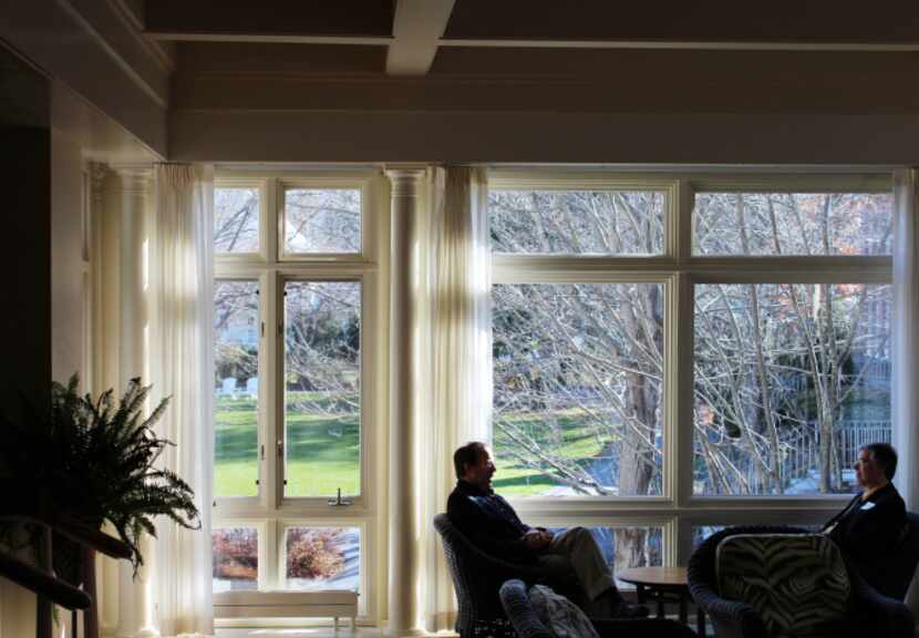 Two businessmen have a late morning in one of the many reception areas at the Woodstock Inn.