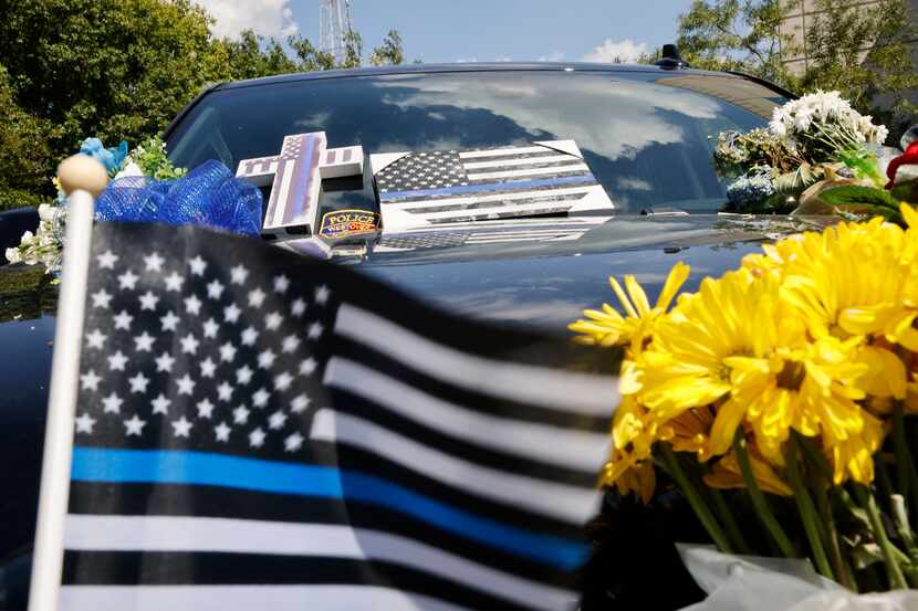 A makeshift memorial for Arlington police Officer Darrin McMichael sits outside the...