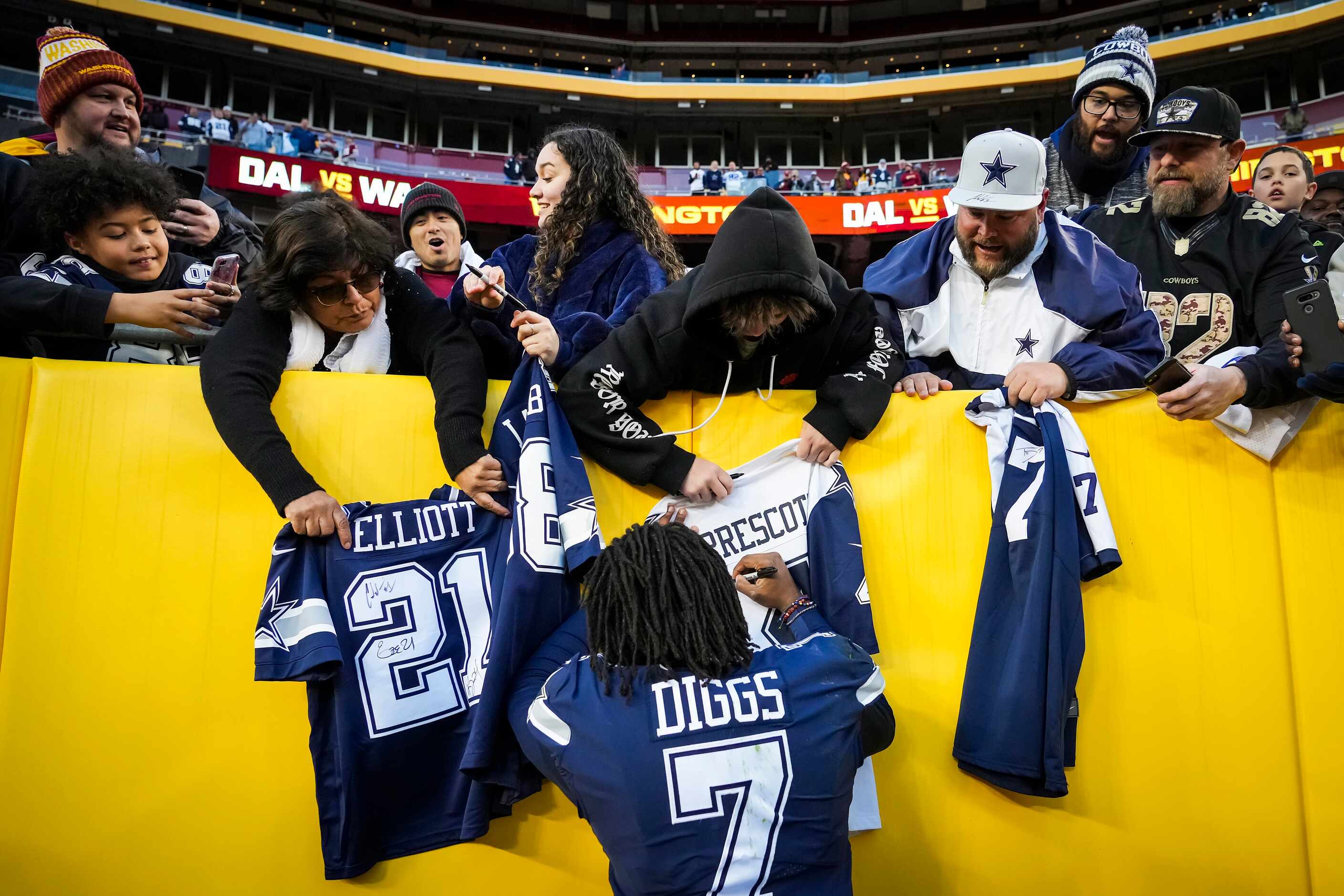 Dallas Cowboys defensive back Trevon Diggs signs autographs for fans as he leaves the field...
