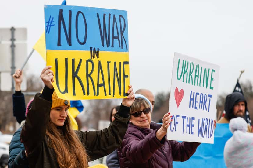 From left, Iryna Sychyk and Linda Camerlin participate in a rally against the war in Ukraine...