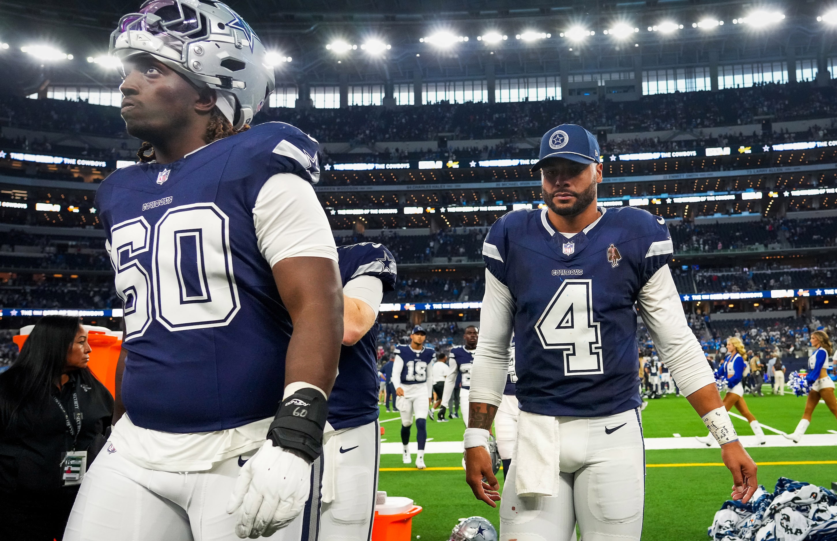 Dallas Cowboys quarterback Dak Prescott (4) and offensive tackle Tyler Guyton (60) leave the...