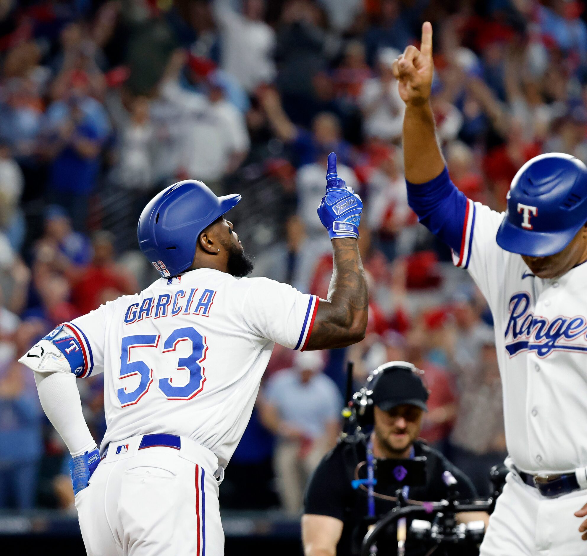 Texas Rangers Adolis Garcia (53) points skyward along with third base coach Tony Beasley...