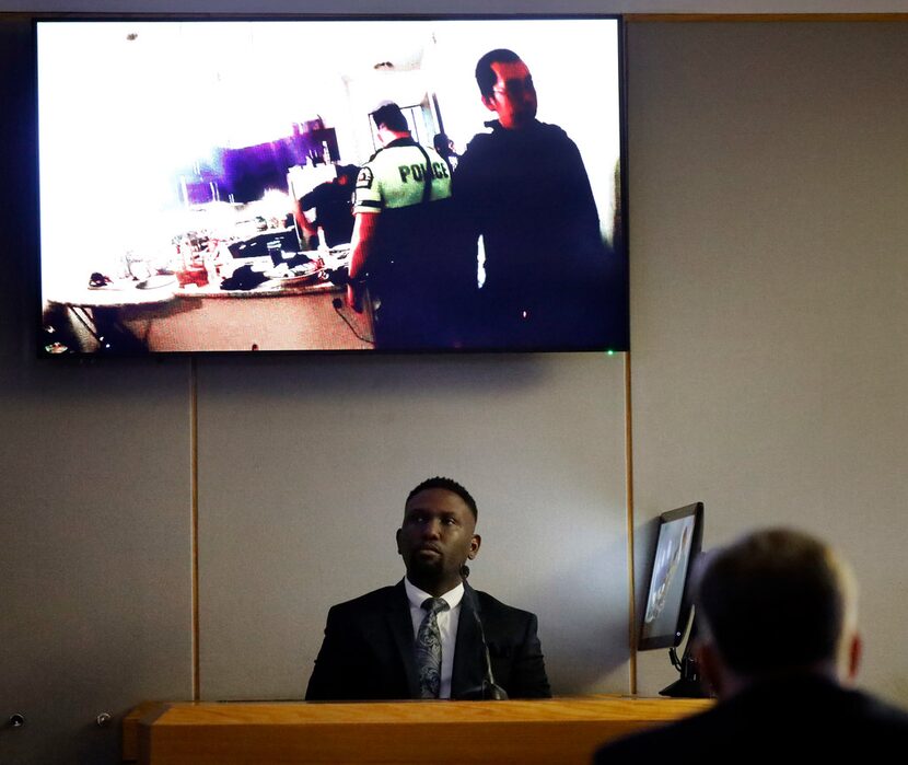 Dallas police Officer Michael Lee watches footage from his body camera on the night he and...