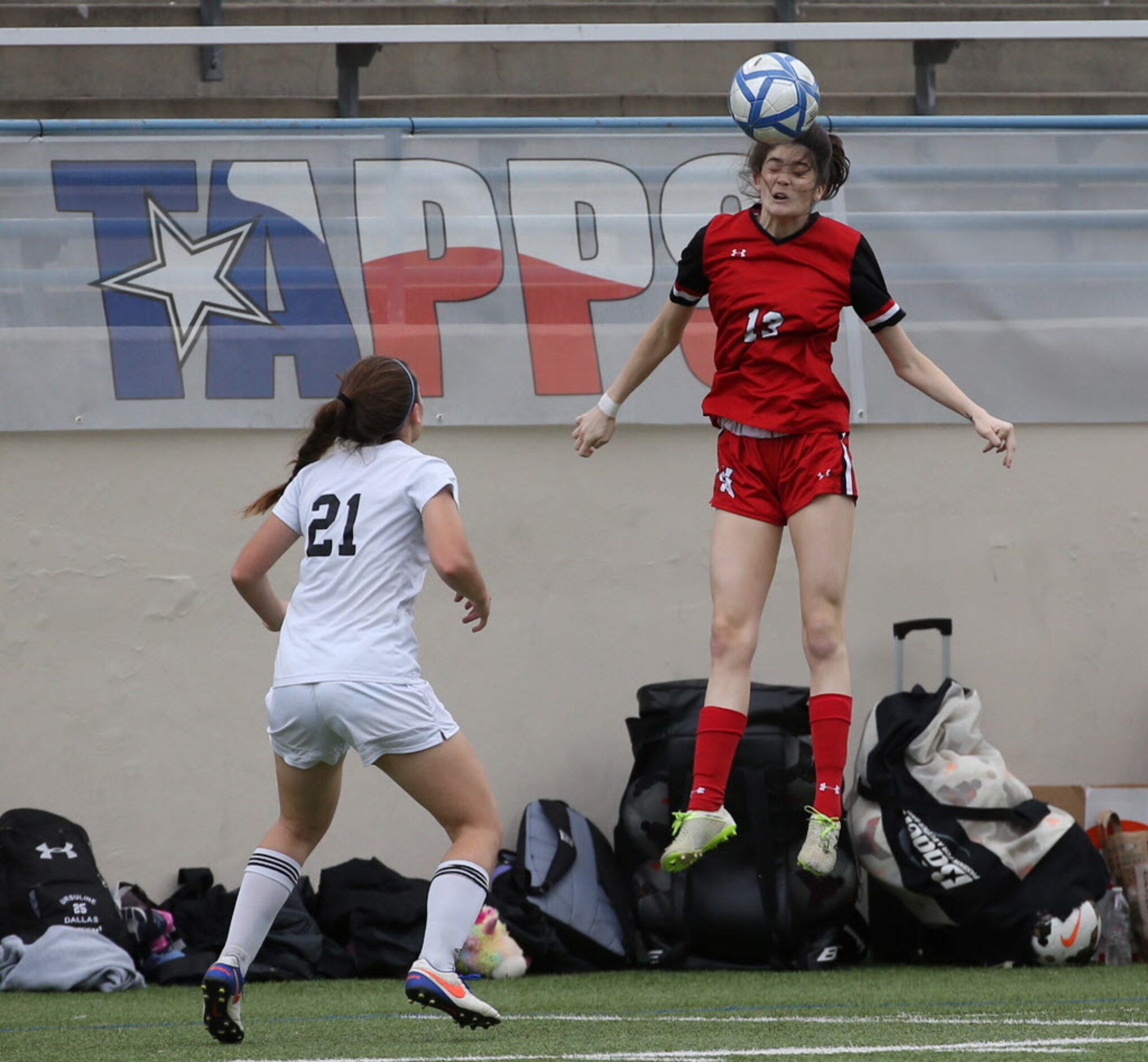 Ursuline Academys Adreinne Bland (13) heads the ball against St. Agnes Academys Anna Hanel...