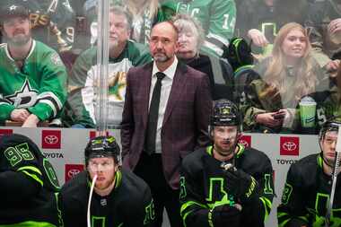 Dallas Stars head coach Pete DeBoer looks on from the bench during the third period of an...