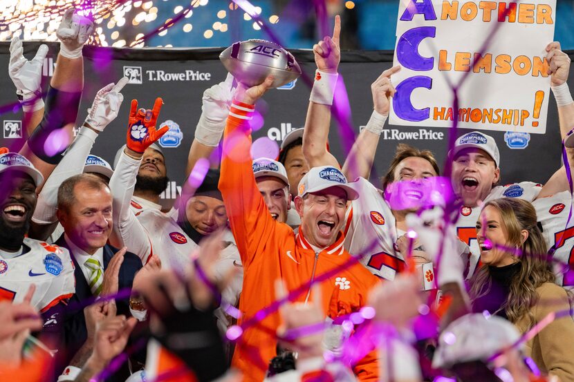 Clemson head coach Dabo Swinney celebrates with the trophy after defeating SMU during the...