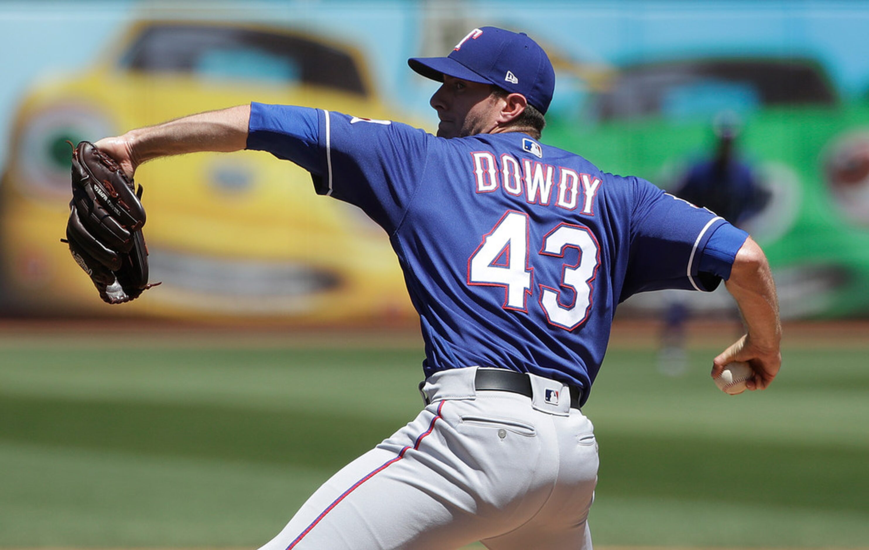 Texas Rangers pitcher Kyle Dowdy throws against the Oakland Athletics during the first...