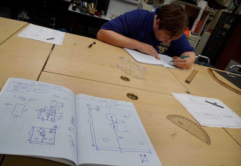 Arlington Lamar robotics team member Timmy Bauer, 17, works on the team's latest robot...