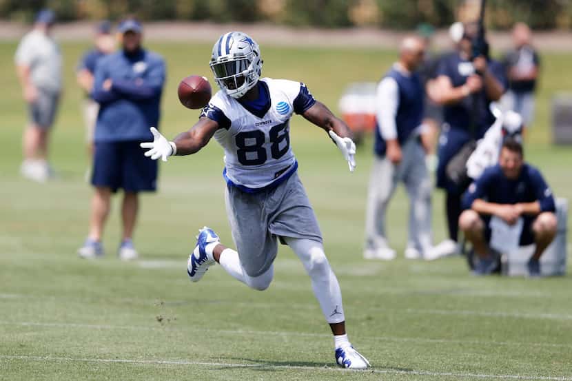 Dallas Cowboys Dez Bryant bobbles the ball before securing the pass in a drill during OTA's...