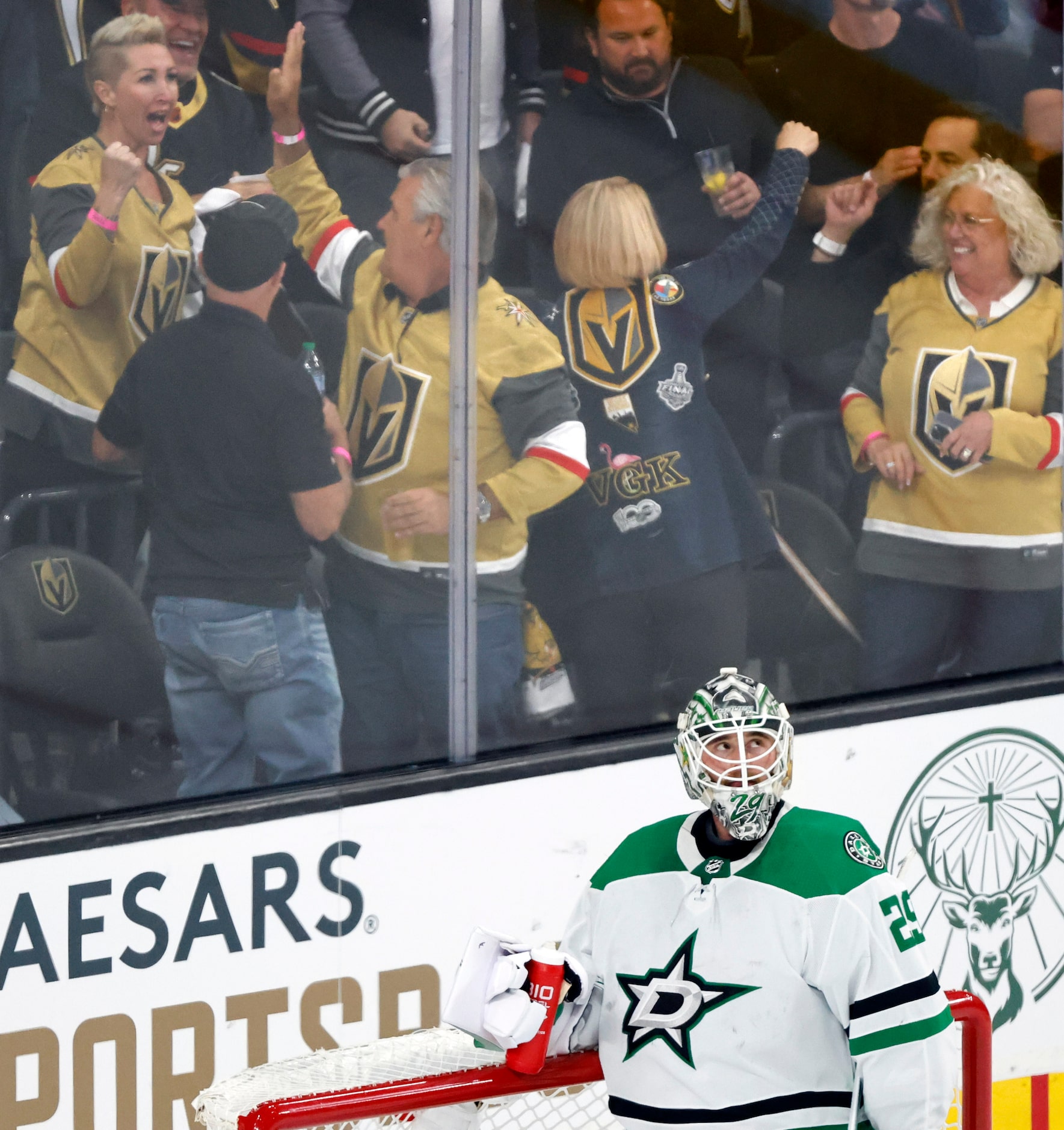 Golden Knights fans celebrate as Dallas Stars goaltender Jake Oettinger (29) reacts after he...