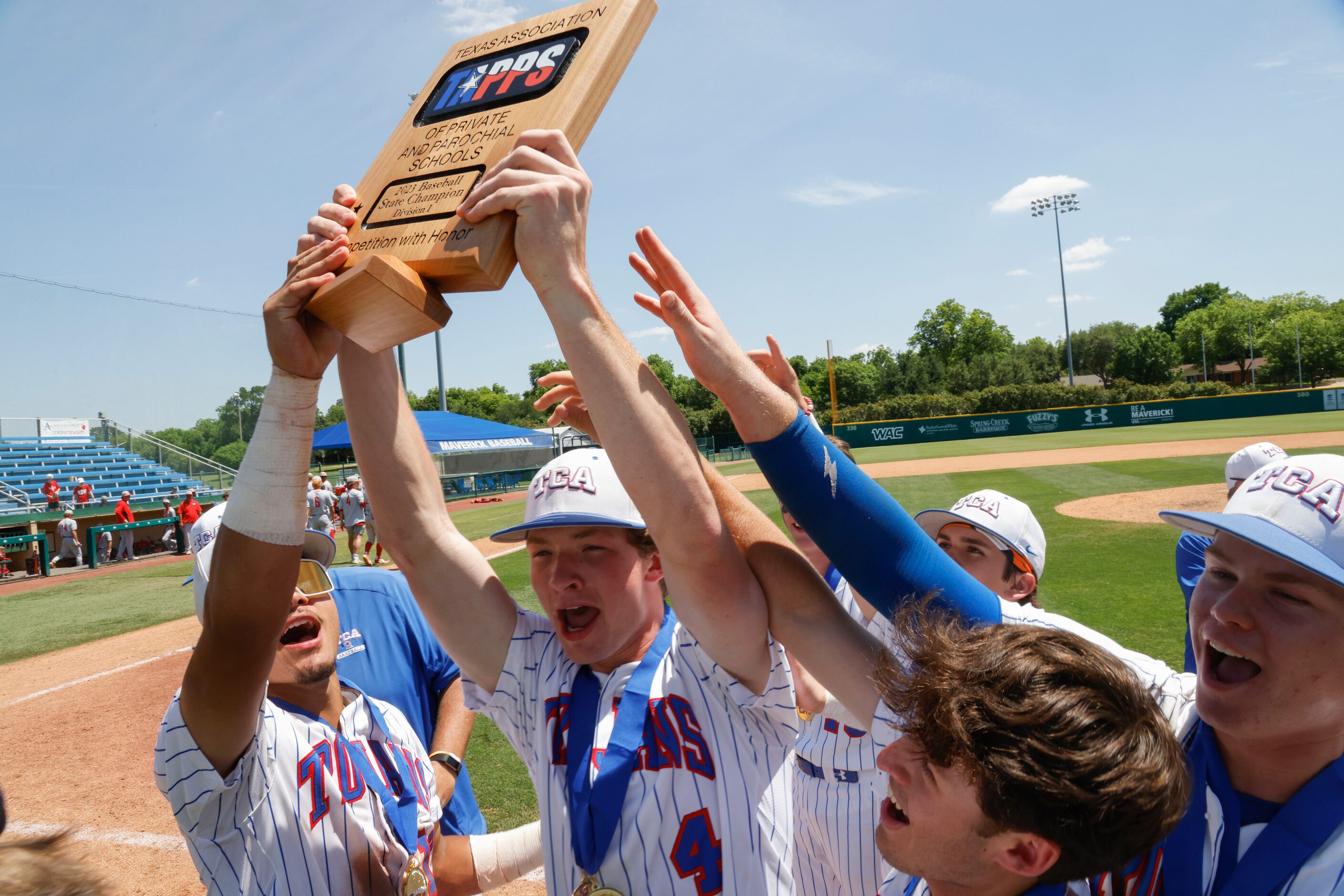 Trinity Christian’s Hayden Heflin (4) holds the championship plaque after defeating Houston...