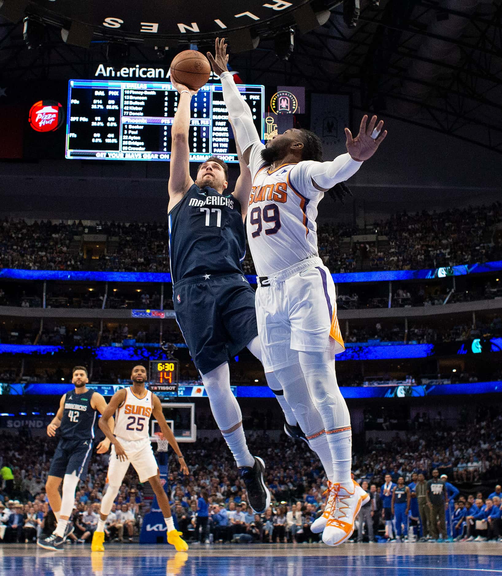 Dallas Mavericks guard Luka Doncic (77) puts up a jumper in the lane against Phoenix Suns...