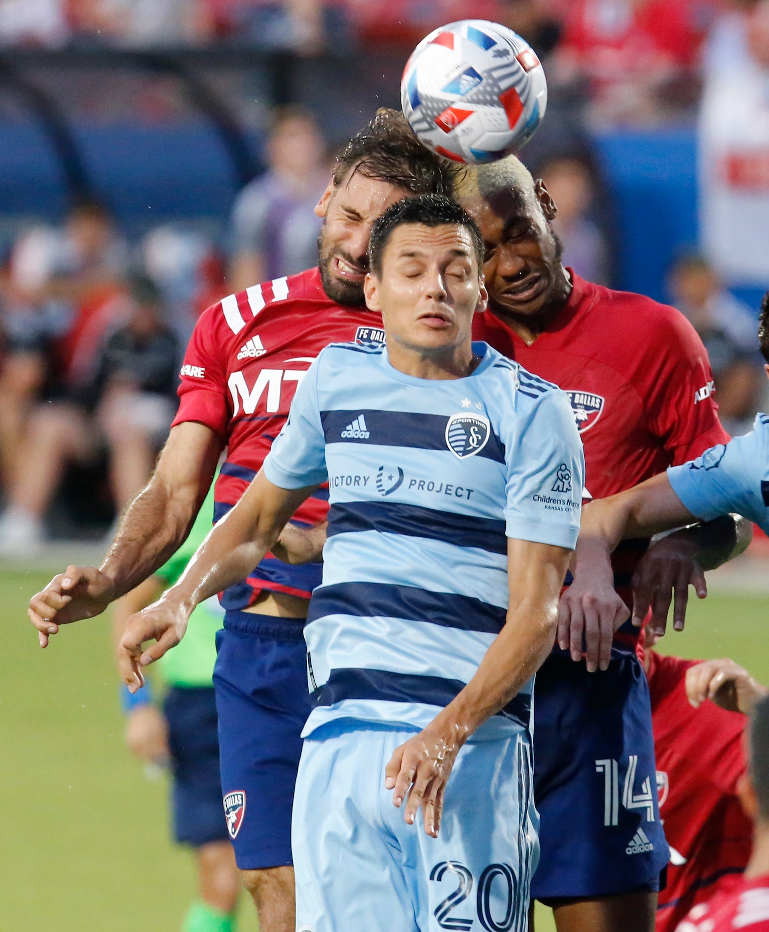 Sporting Kansas City forward Daniel Salloi (20) goes lip for a header with FC Dallas...