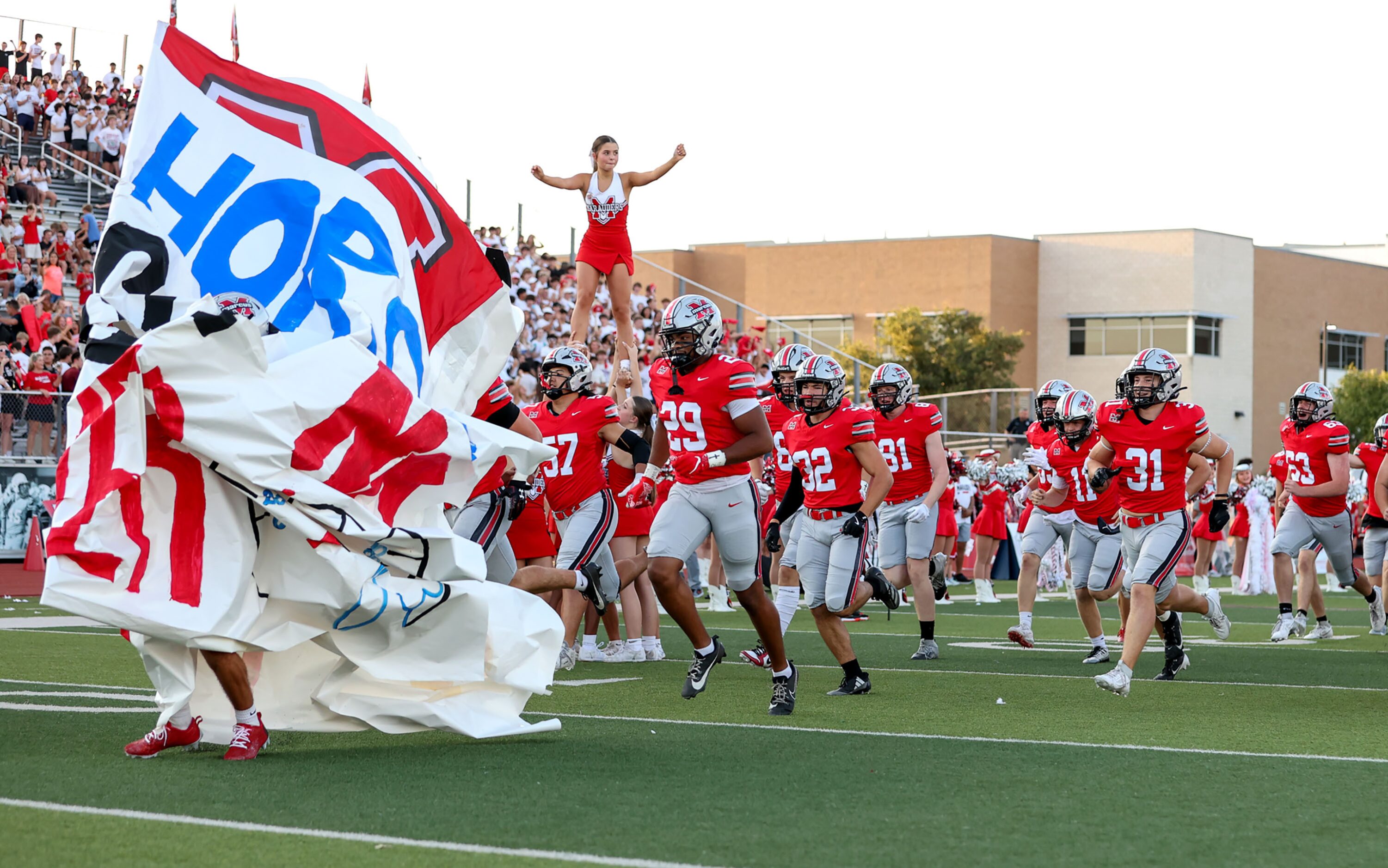 The Flower Mound Marcus Marauders enter the field to face Ricahardson Pearce in a...