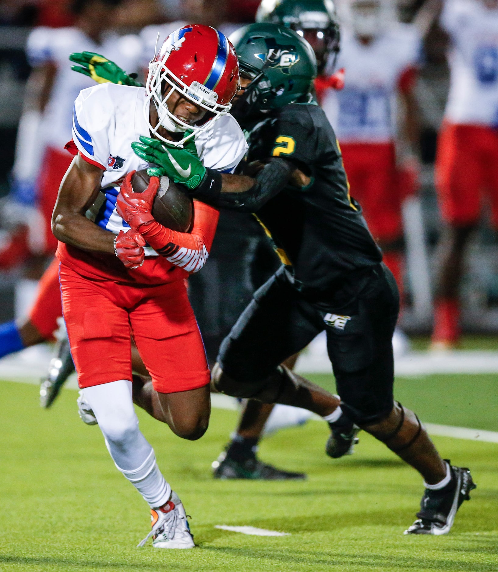 Duncanville senior punt returner Davion Bluitt (14) slips a tackle from DeSoto senior Mike...