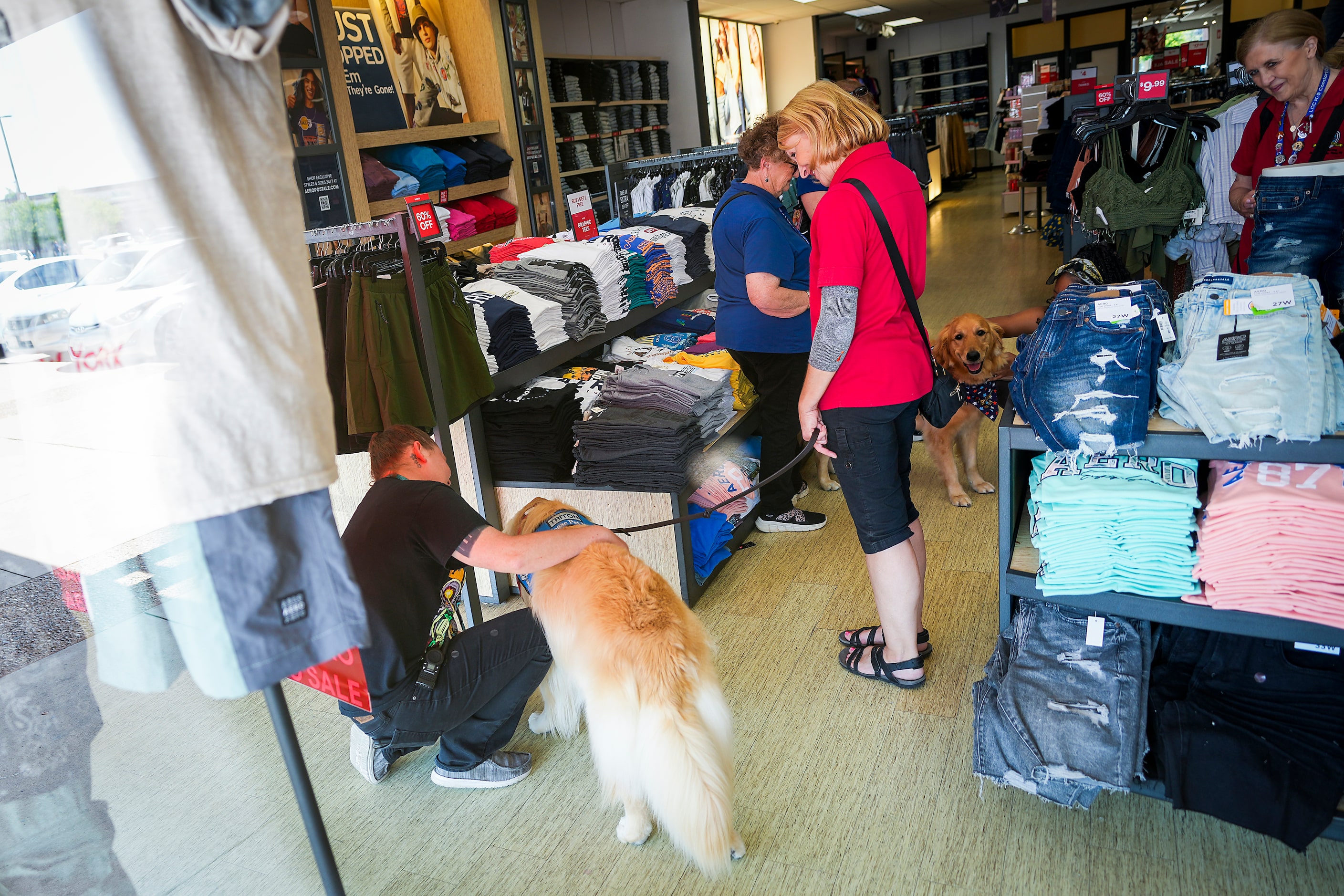 A group from LCC K-9 Comfort Dog Ministry visits stores at the Allen Premium Outlets on...