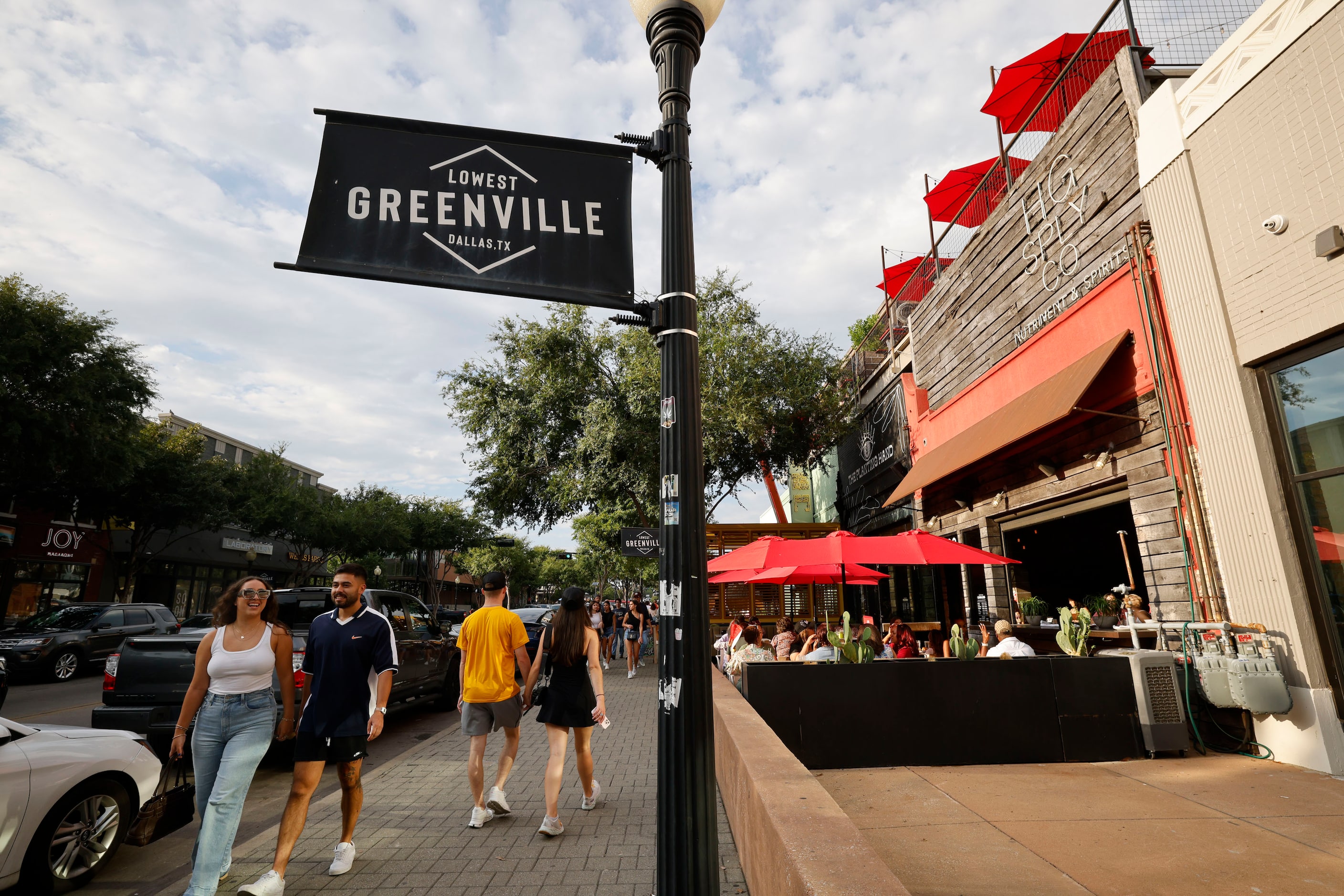 People walk by HG Sply Co. in the Lower Greenville neighborhood in Dallas, Saturday, Sept....