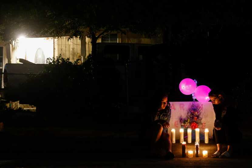 Friends of late Aureanna Hernandez, 21, including Hayley Marie (right) remain by a makeshift...