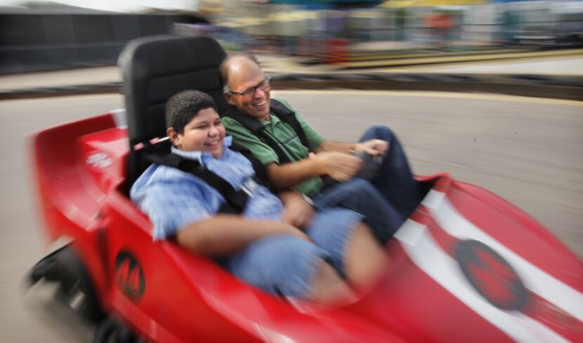 Steve Blow and 12-year-old Michael Gonzalez take a spin on the go-kart track at Celebration...