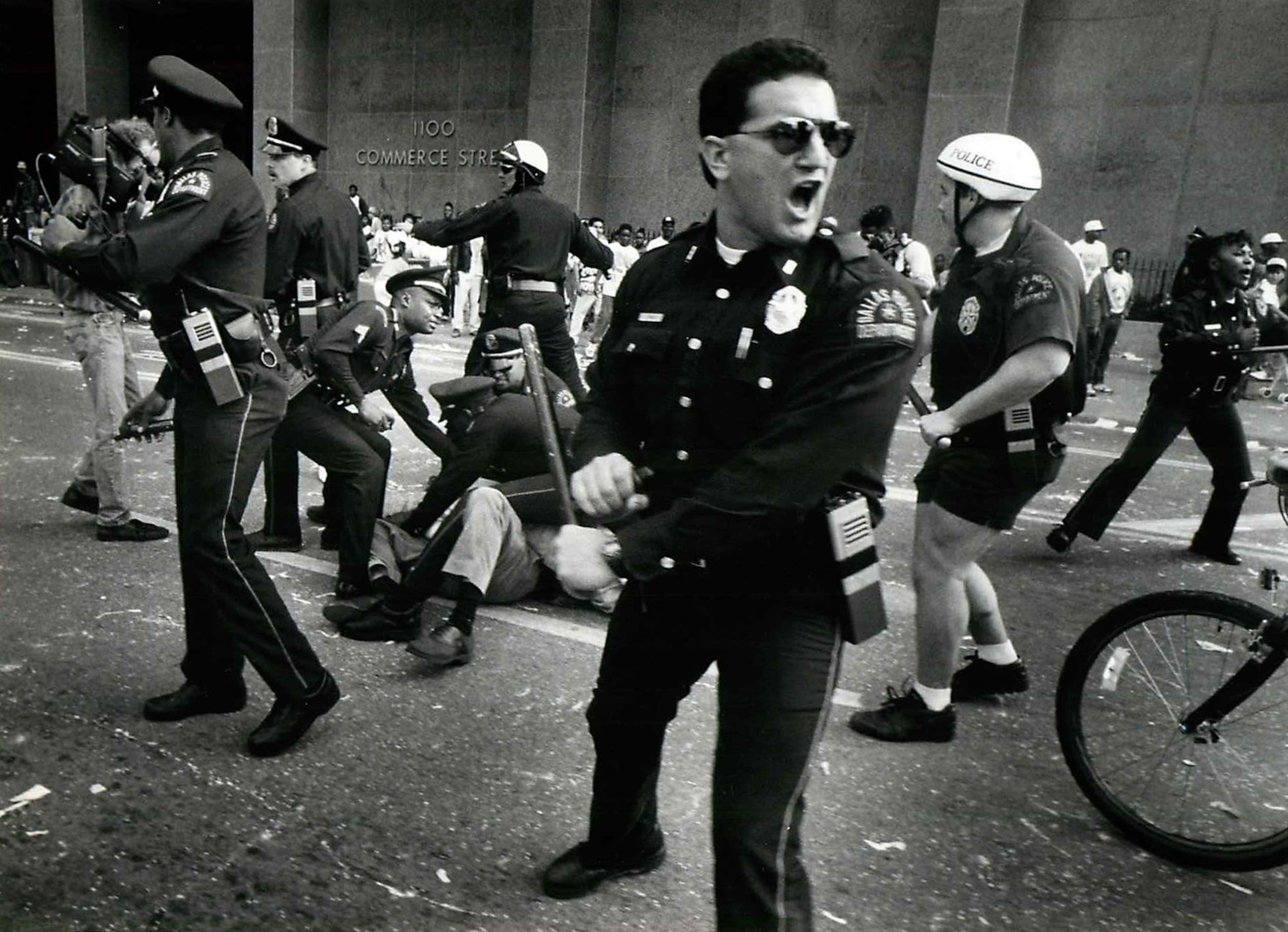 The police officer bending down at left is David Brown (Dallas police SWAT Sgt. David...