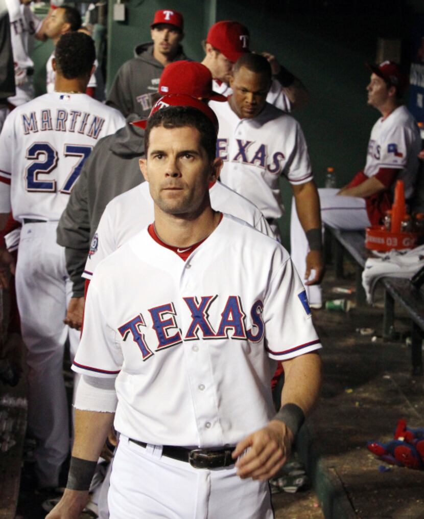 Texas first baseman Michael Young walks to the clubhouse after the final out in Texas' 5-1...