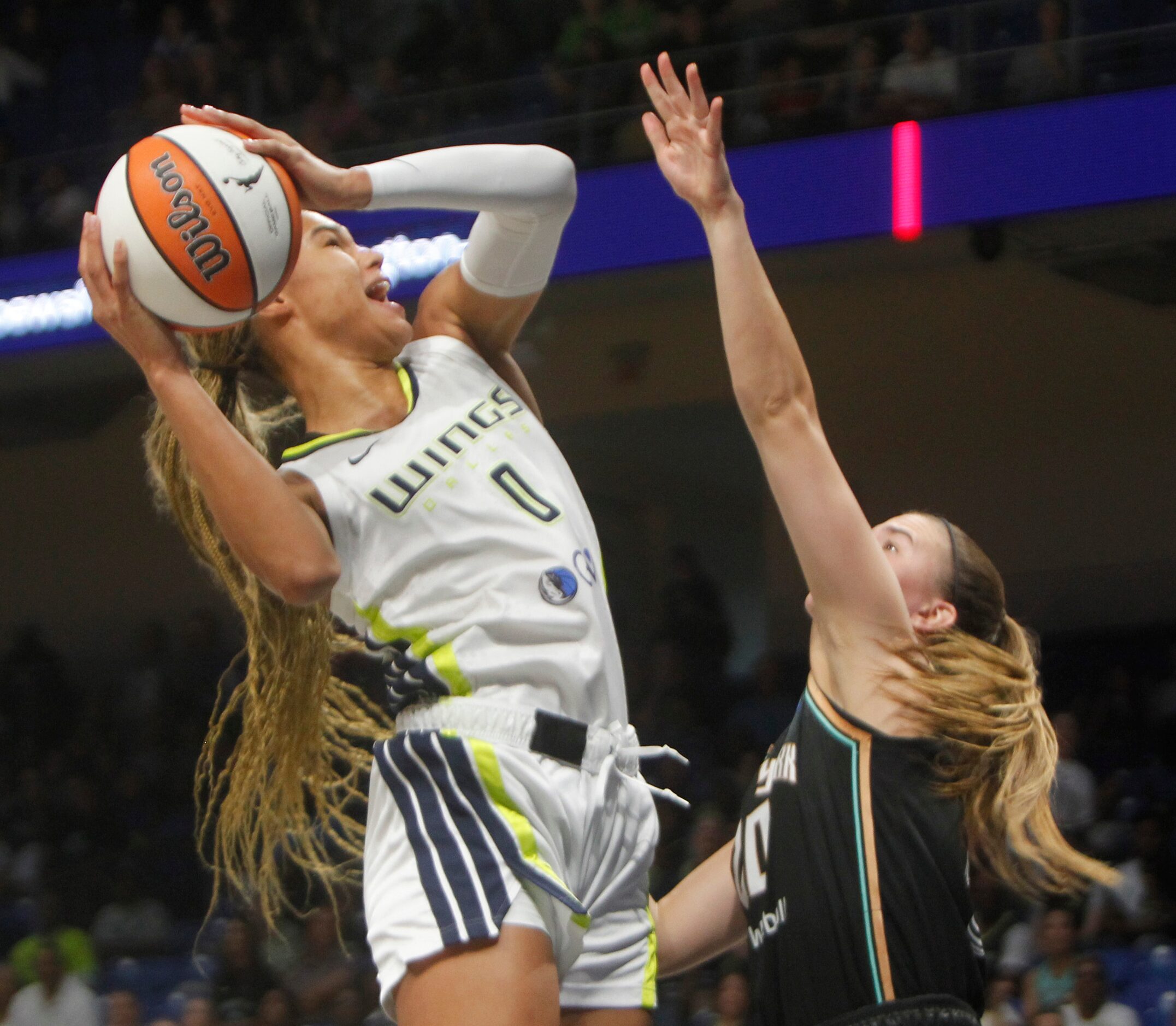 Dallas Wings forward Satou Sabally (0) shoots over the defense of New York Liberty guard...