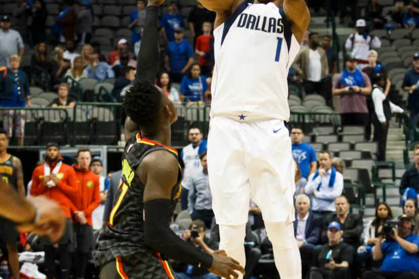 Dallas Mavericks guard Dennis Smith Jr. (1) misses a shot over Atlanta Hawks guard Dennis...