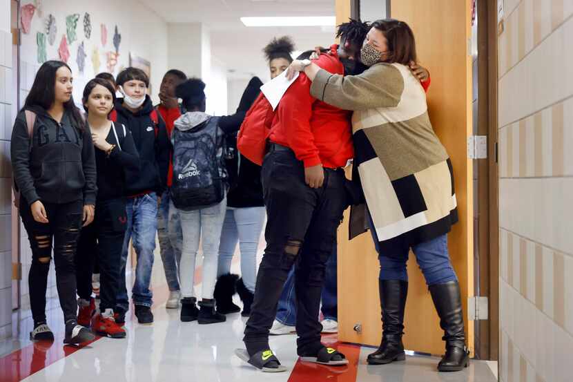 Terrell ISD Superintendent Georgeanne Warnock (right) gives a hug to Cedrick Taylor after he...