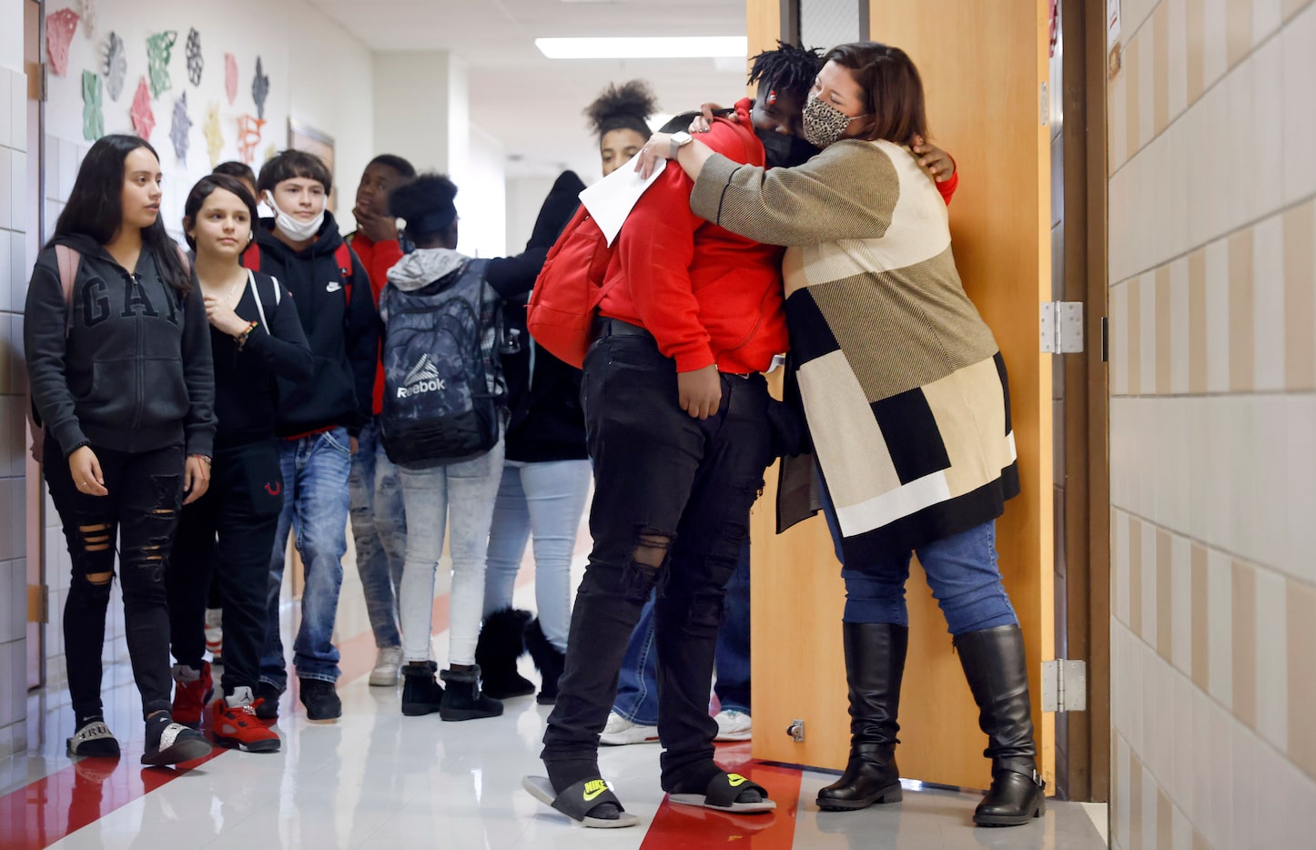 Terrell ISD Superintendent Georgeanne Warnock (right) gives a hug to Cedrick Taylor after he...