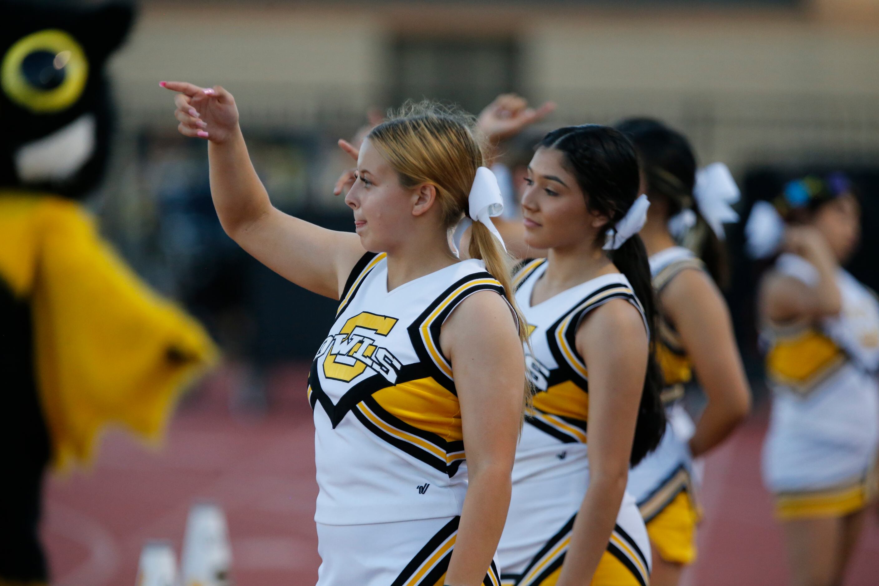 Garland High cheerleaders signal a first down during the first half a high school football...