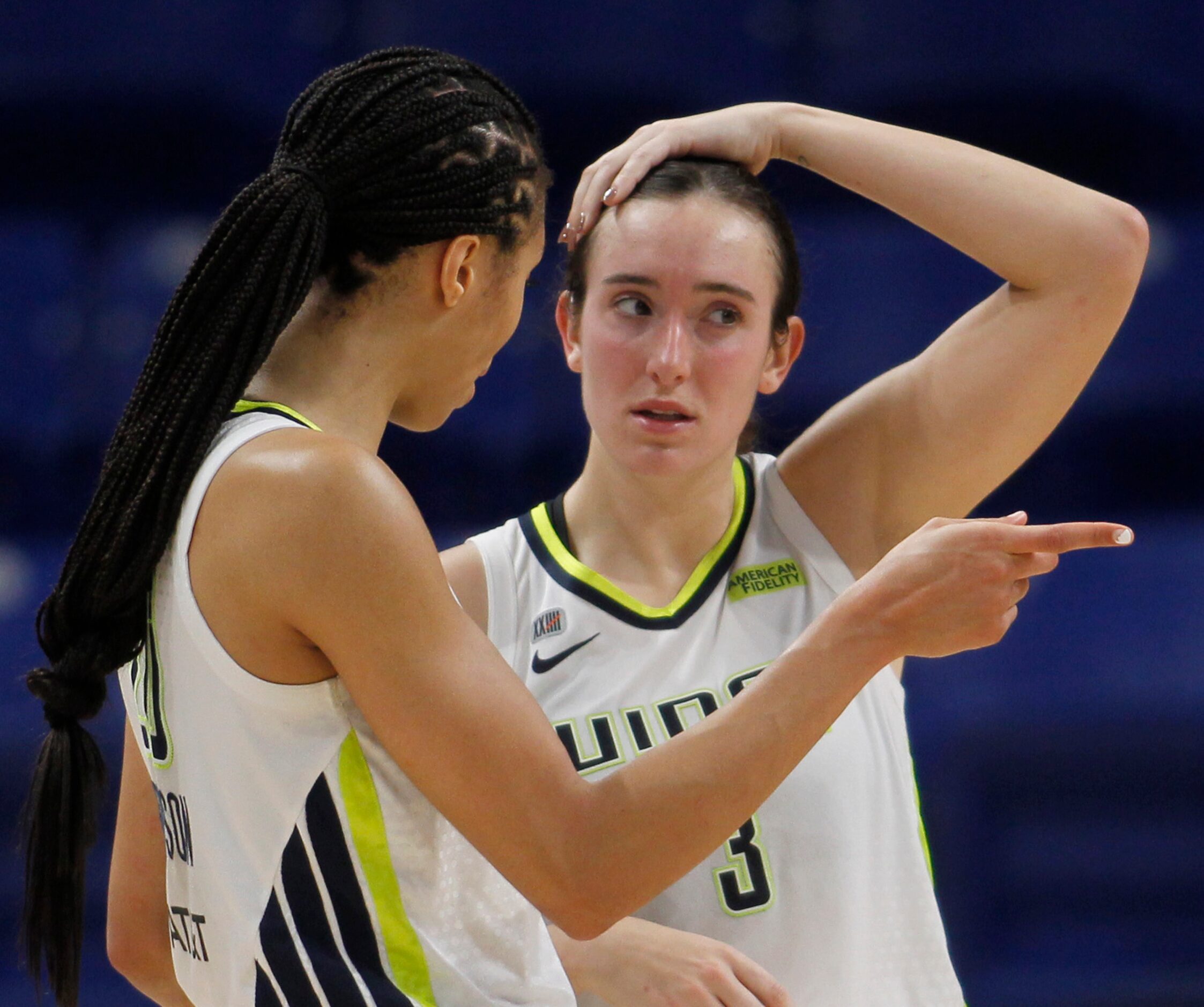 Dallas Wings guard Marina Mabrey (3), right, converses Wings forward Isabelle Harrison (20)...