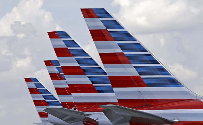 Tails of four American Airlines passenger planes parked at Miami International Airport.
