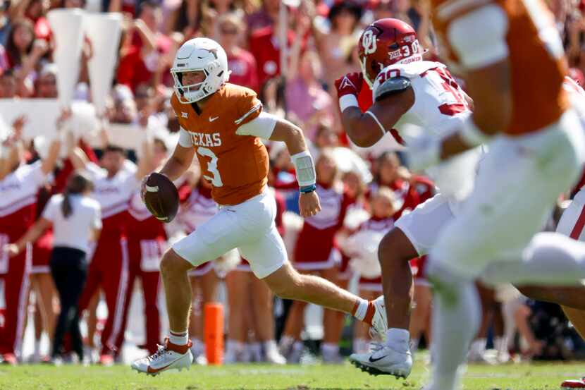 Texas quarterback Quinn Ewers (left) runs with the ball against Oklahoma during the first...