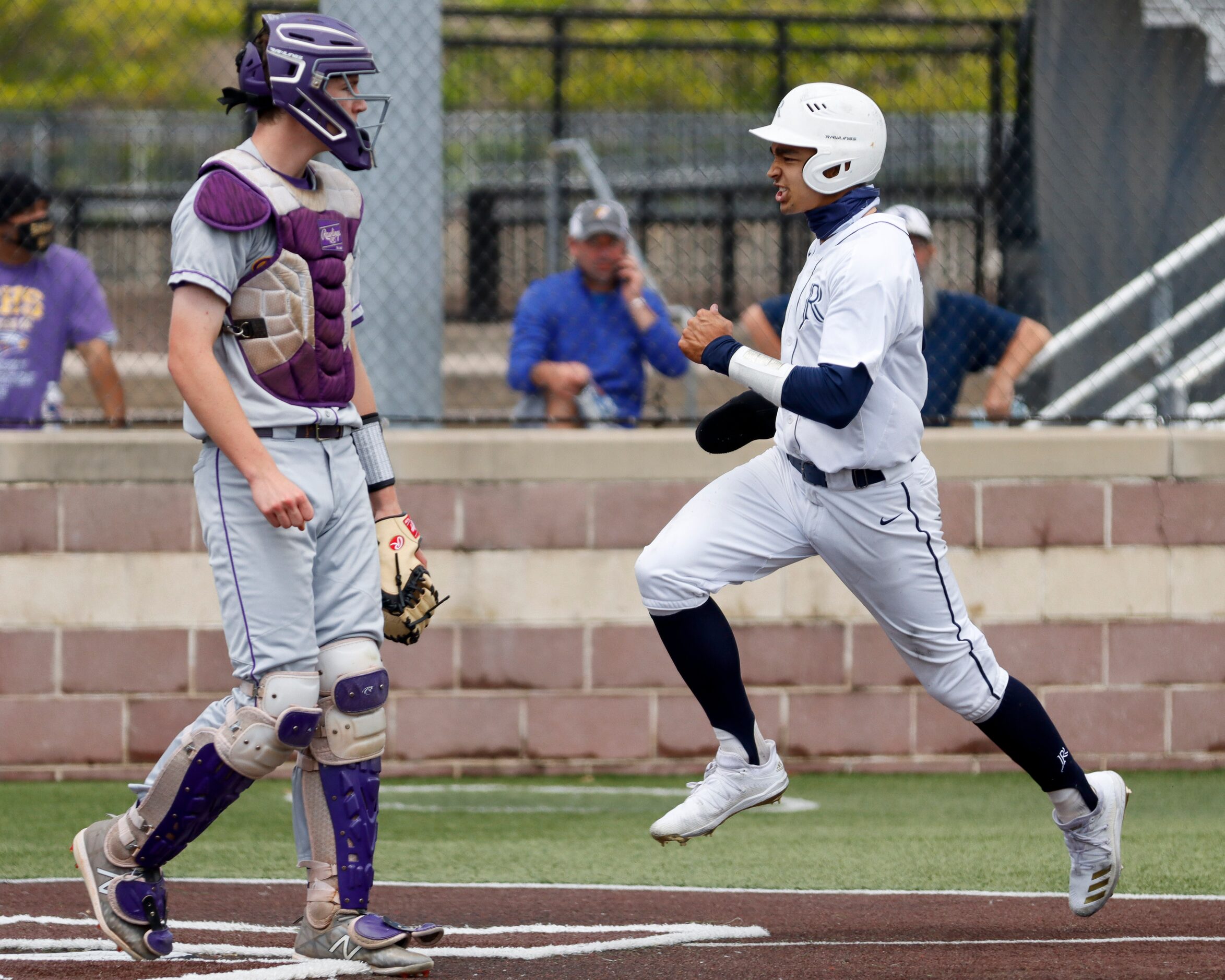 Richardson catcher Marcus Peters watches as Jesuit shortstop Jordan Lawlar scores a run...