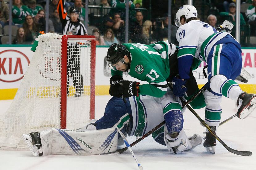 Dallas Stars center Devin Shore (17) crashes into Vancouver Canucks goaltender Jacob...