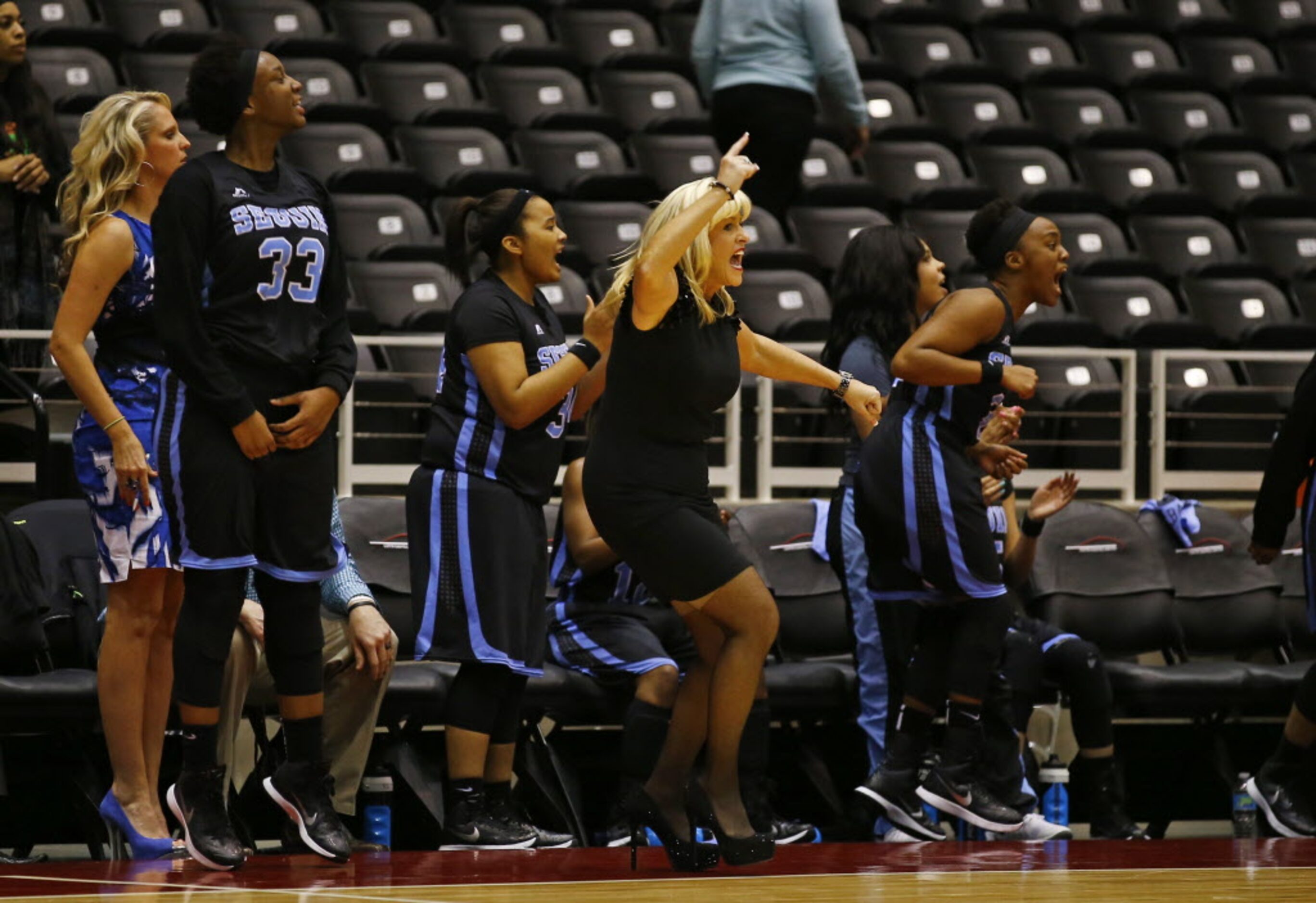 Arlington Seguin head coach Courtney Phillips and the Sequin bench react after making a...