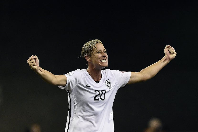 USA forward Abby Wambach celebrates after winning the semi-final football match between USA...