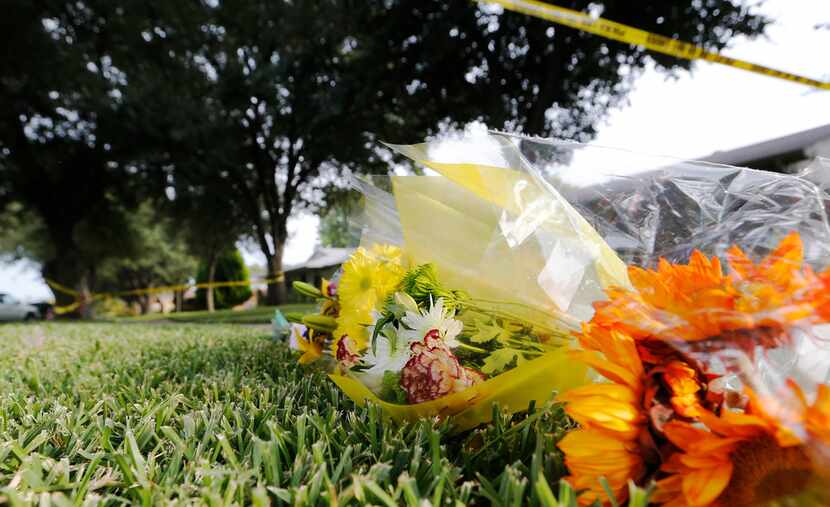 Flowers sit at a makeshift memorial for the victims lost in a shooting at the 1700 block of...
