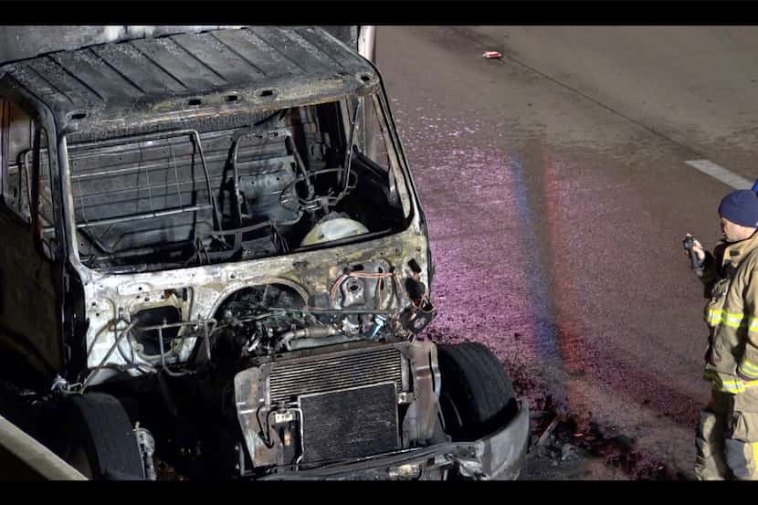 A burned-out truck sits along State Highway 121 in Grapevine after it caught fire Friday...