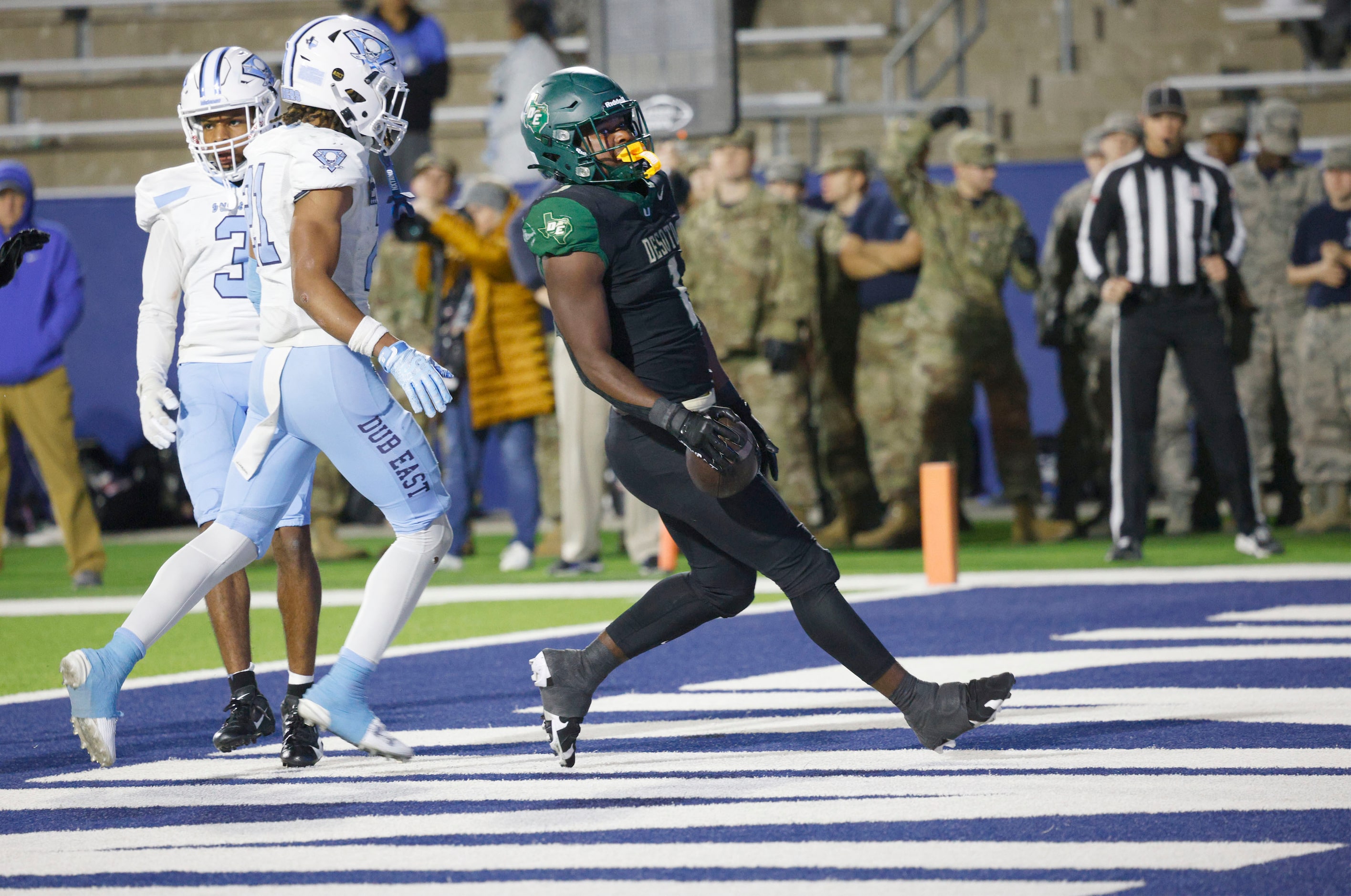 DeSoto's Deondrae Riden Jr. (1) scores a touchdown over Wylie East's Jamal Olford (3) and...