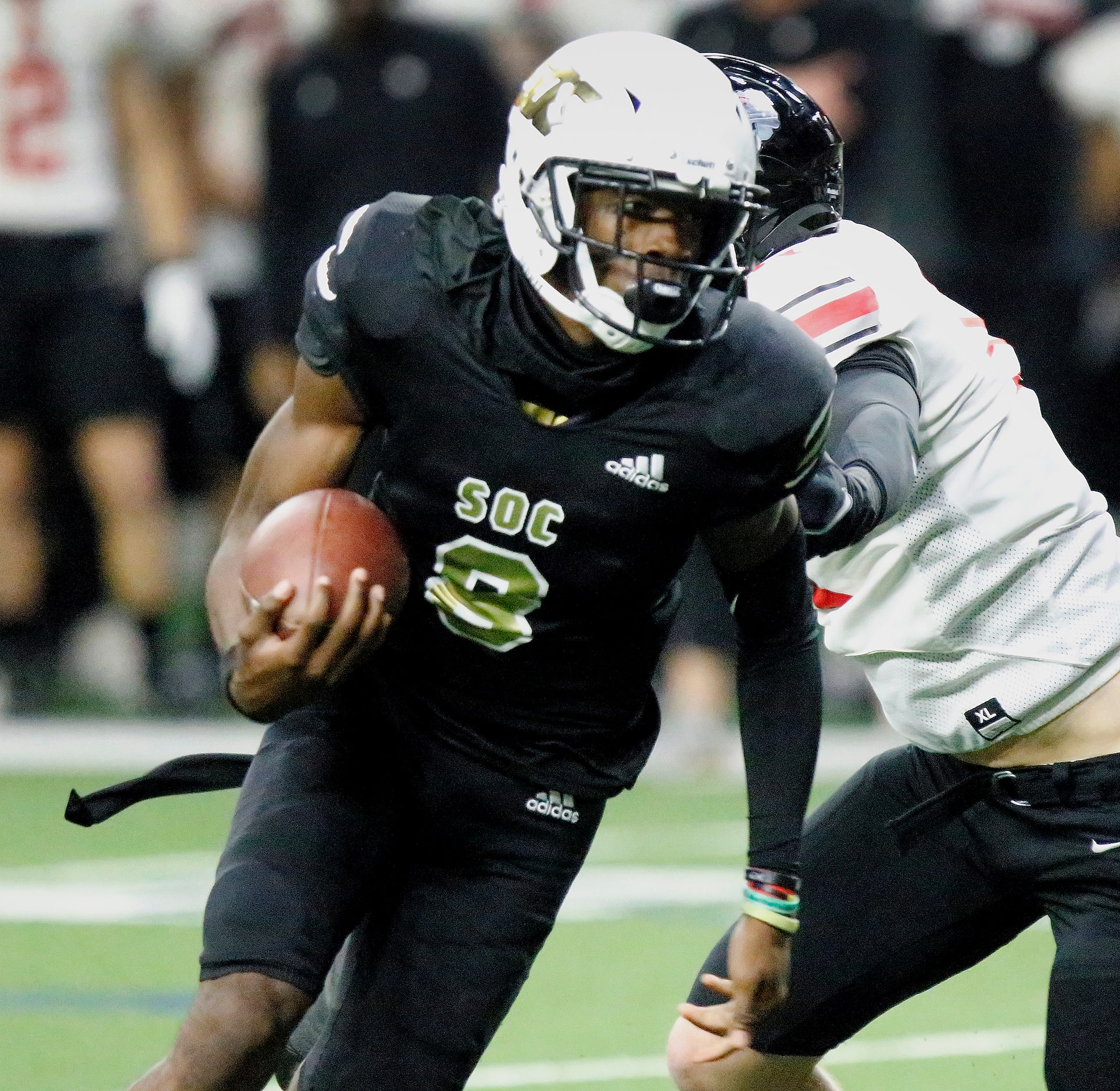 South Oak Cliff High School quarterback Kevin Henry-Jennings (8) runs the ball for the...