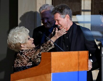 Country music singer Randy Travis is embraced by emcee, Brenda Lee.