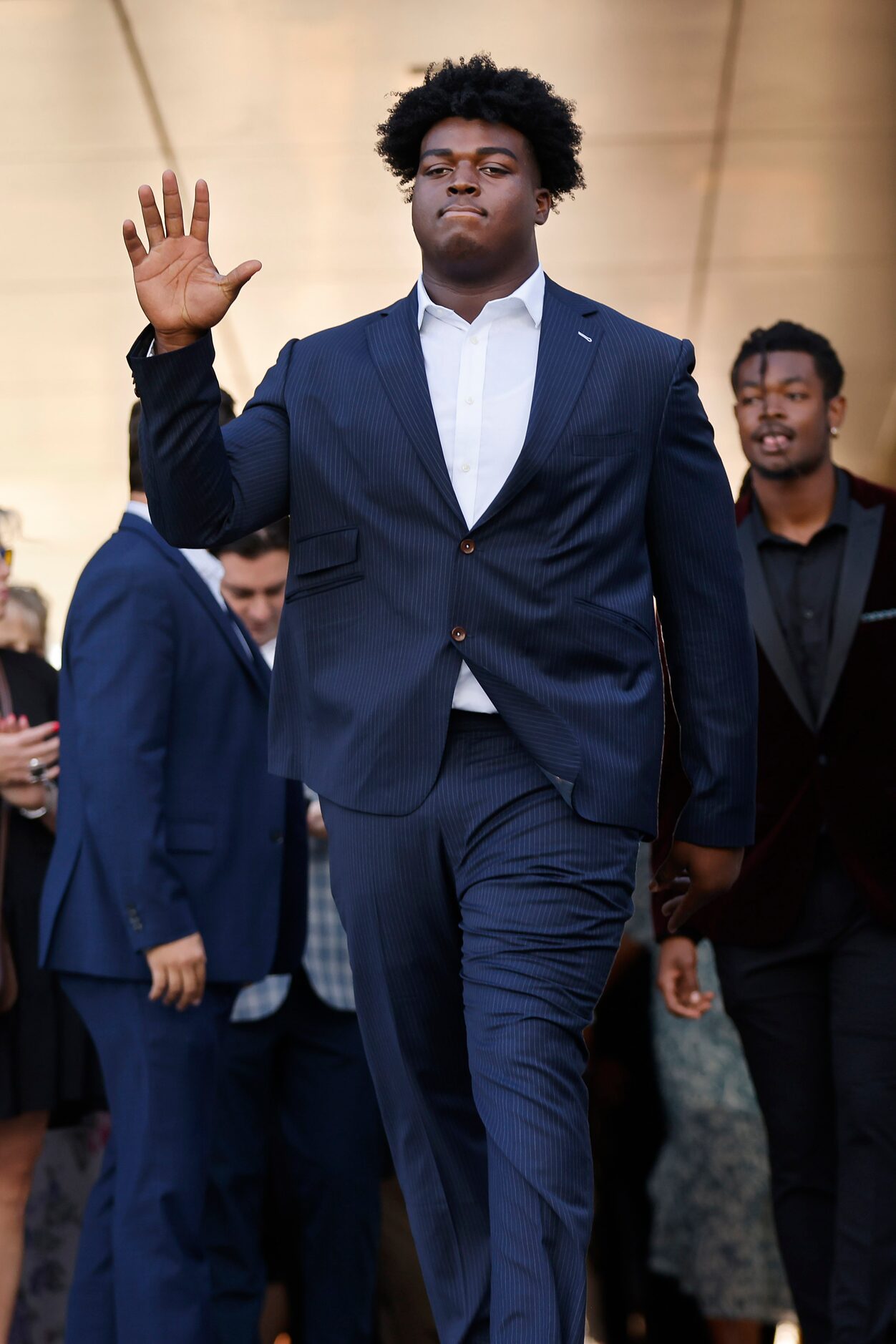 Dallas Cowboys offensive tackle Tyler Smith waves to fans as he arrives to the Dallas...