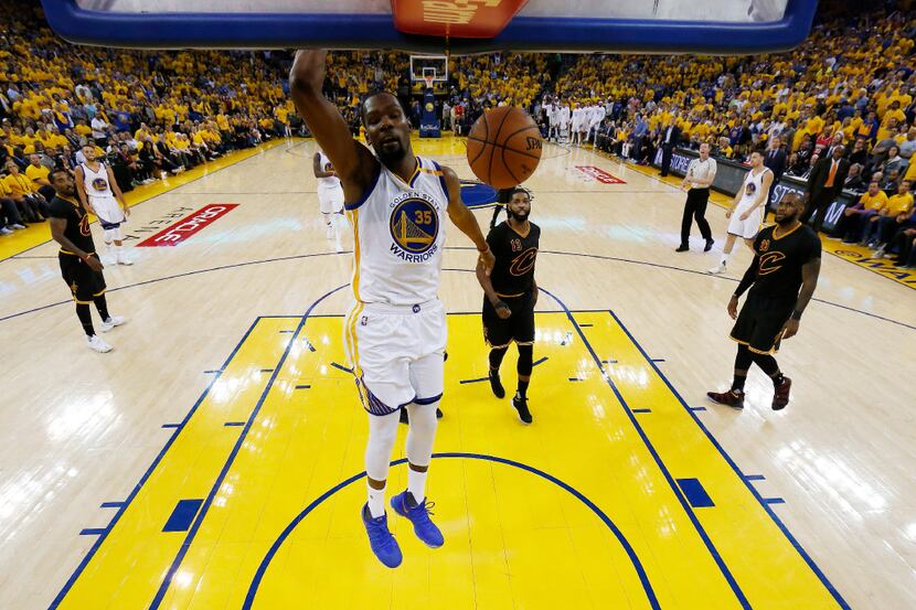 Golden State Warriors' Kevin Durant (35) dunks against the Cleveland Cavaliers during the...