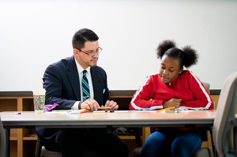 Armando Banchs, a volunteer, tutors Emari Burks in the art of writing. 826 aims to make...