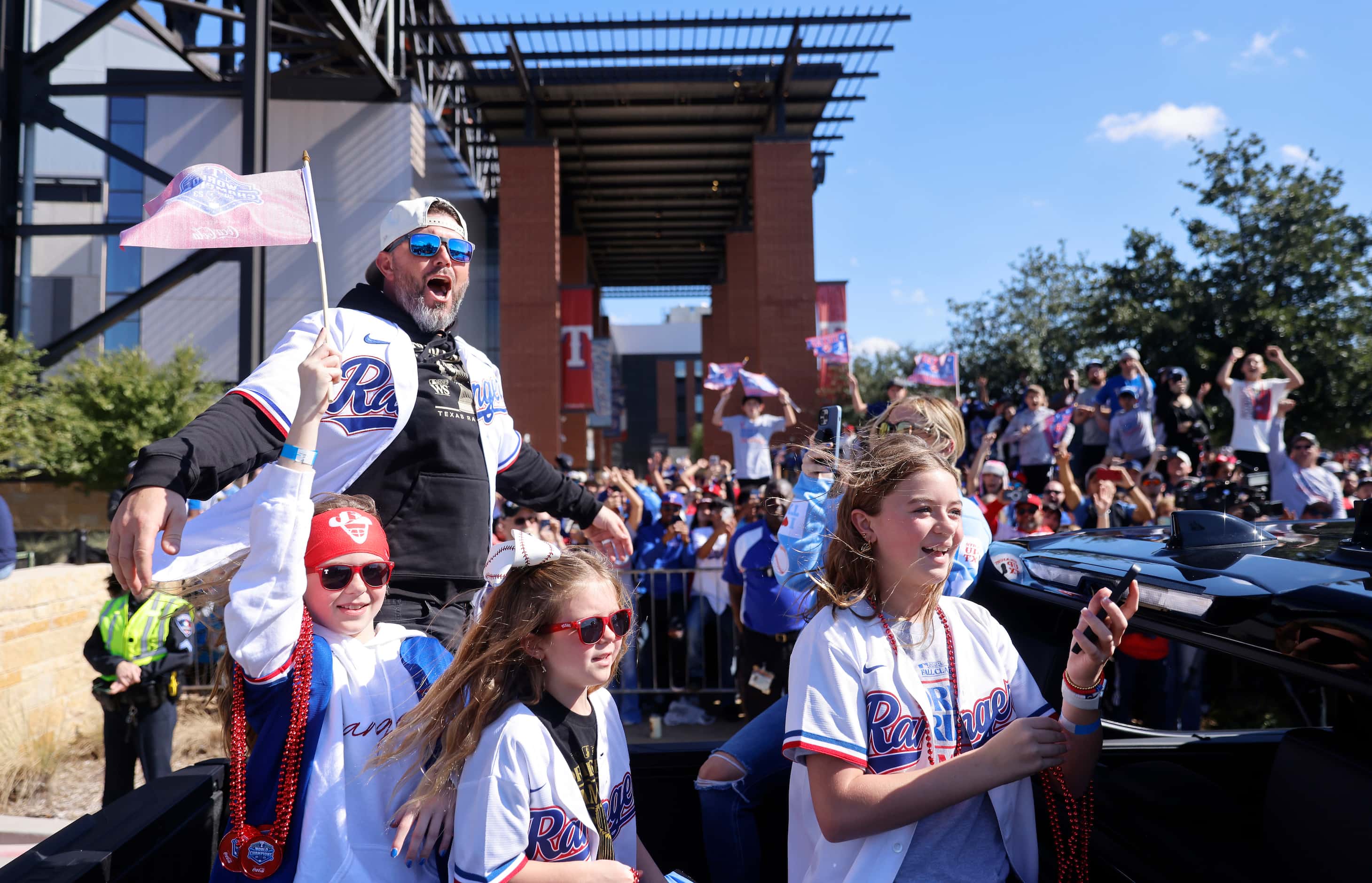 Texas Rangers caching coach Bobby Wilson and his family celebrate with fans during the World...