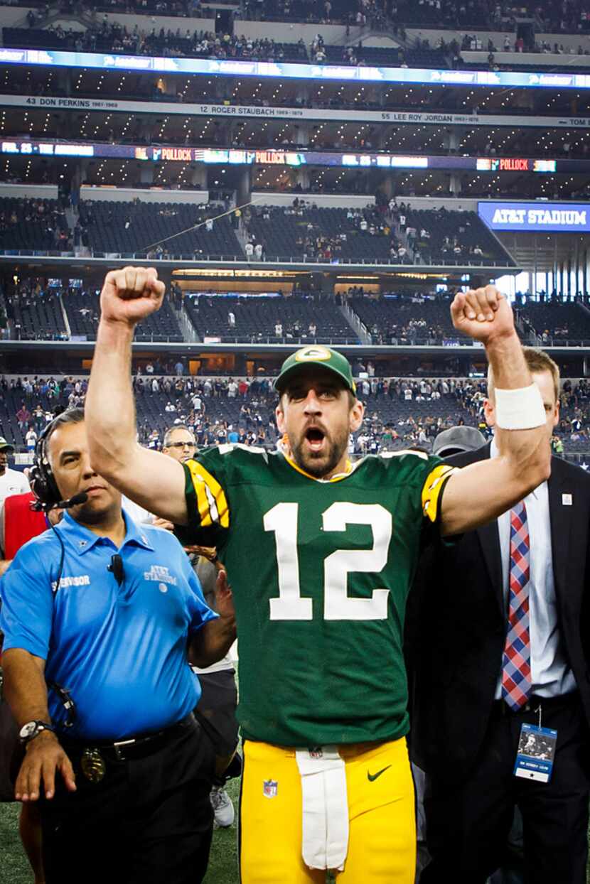 Green Bay Packers quarterback Aaron Rodgers celebrates as he leaves the field following the...