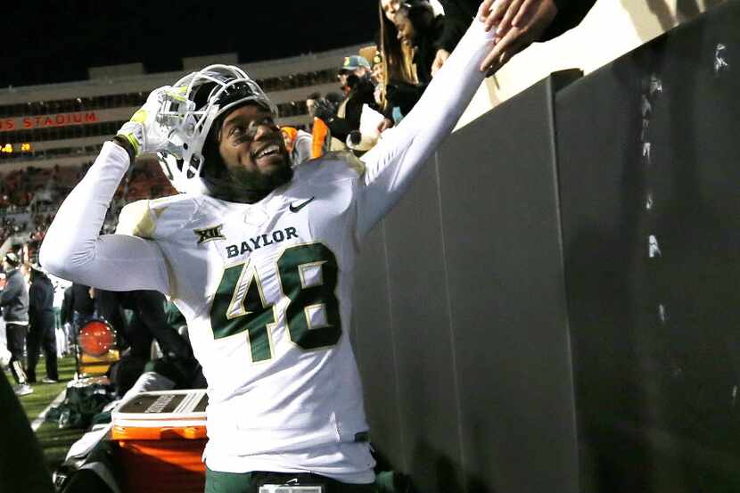 Baylor running back Travon Blanchard (48) celebrates with fans during the fourth quarter of...