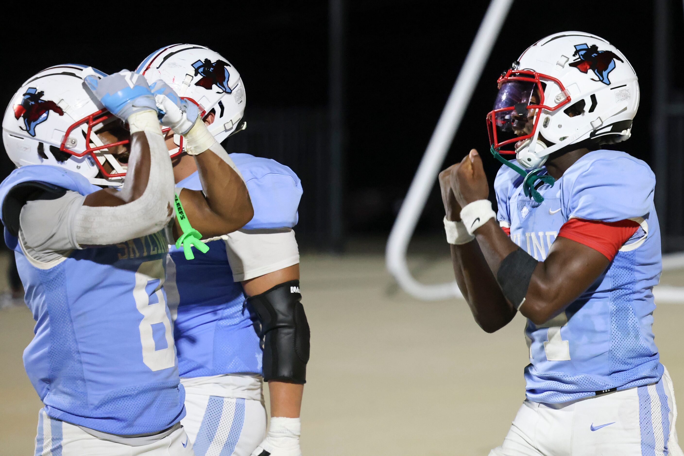 Skyline High’s QB Donte Ware (right) celebrates after scoring a touchdown during the second...